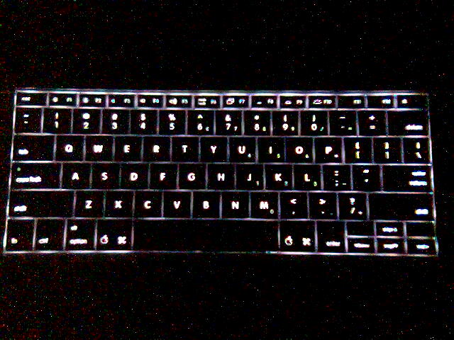 a black lit keyboard that has been edited to match the black light