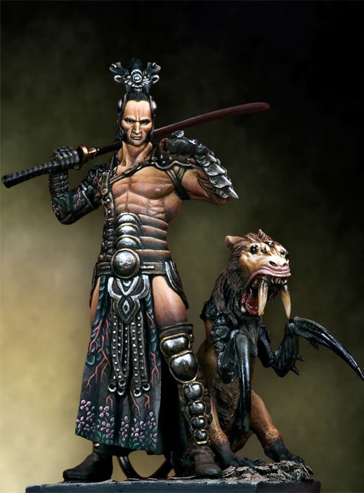 a figurine of a creature and a demon in leathers