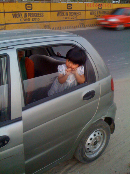 a small child looking out the side window of a car