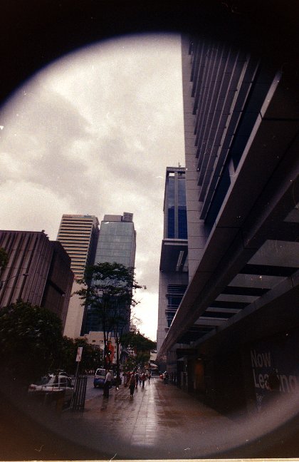 there is some buildings near by with trees on either side