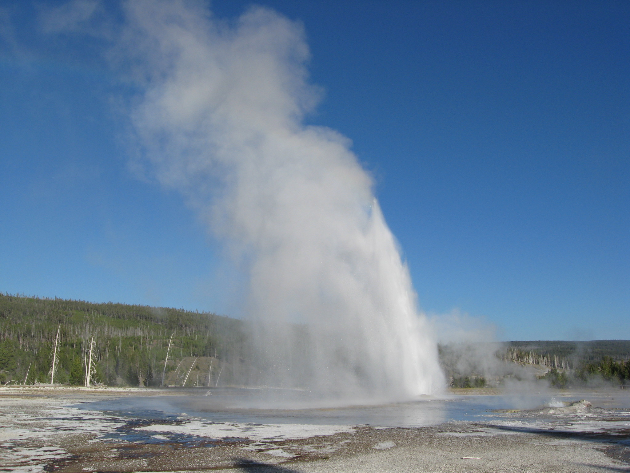 the large geyser gushing water from the ground into the sky