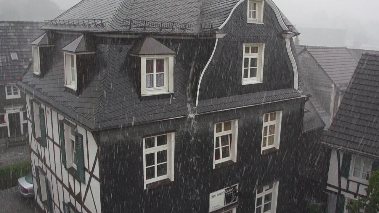an old black house that is on a rainy day