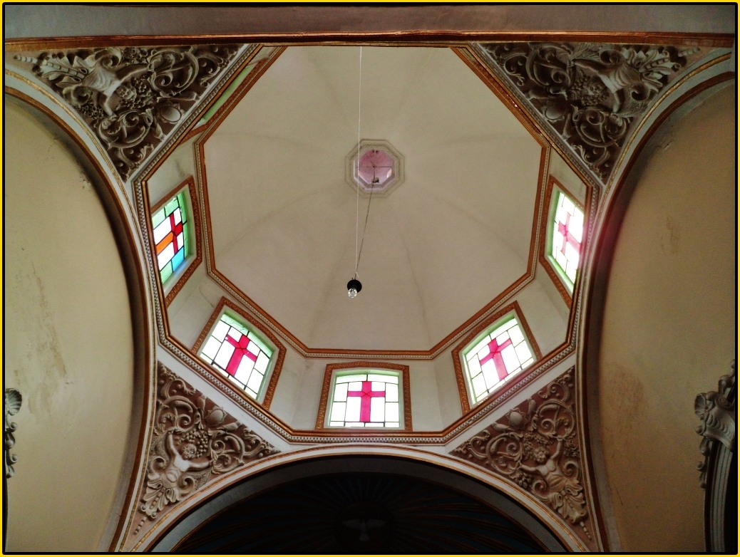 a dome ceiling with stained glass windows and arched arches