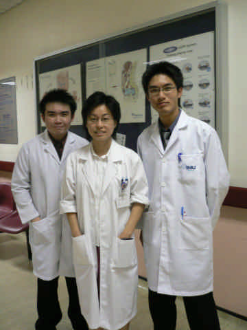 three men and two women are dressed in lab coats