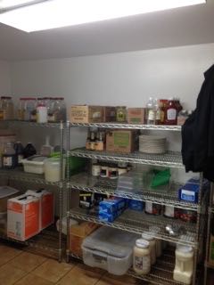 two shelves filled with items inside of a kitchen