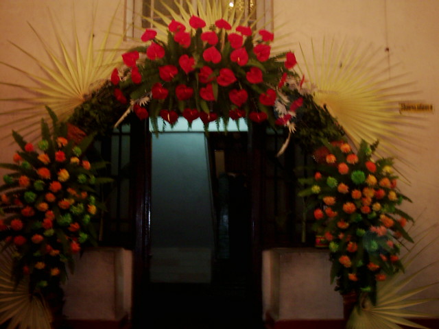 a wreath with flowers at the entrance of a building