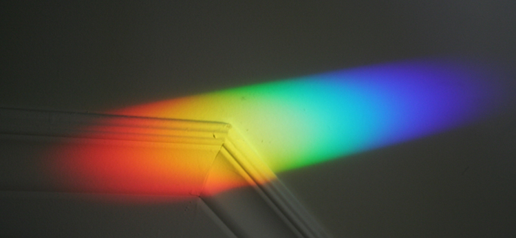 a colored lens reflects the sun from a window