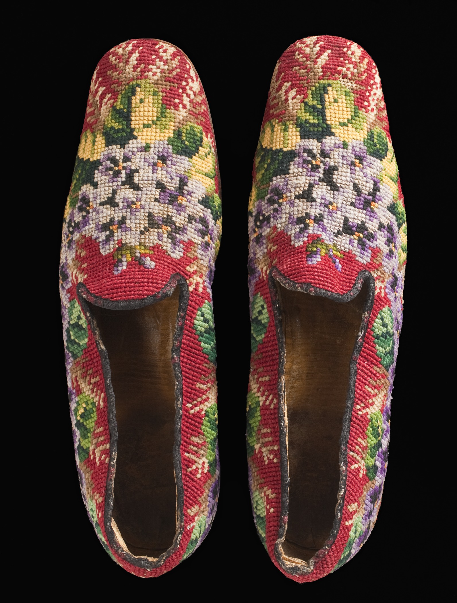 a pair of shoes with floral embroidered outs
