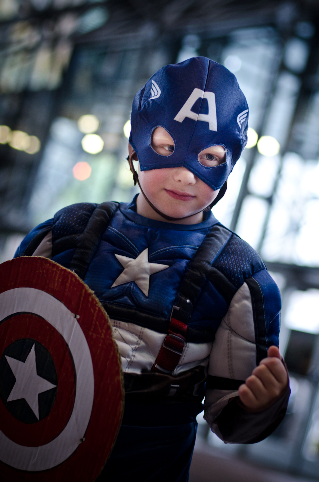 a child in a costume with the shield of captain america on it