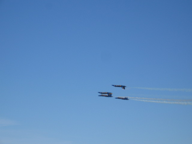 a few airplanes flying in the blue sky