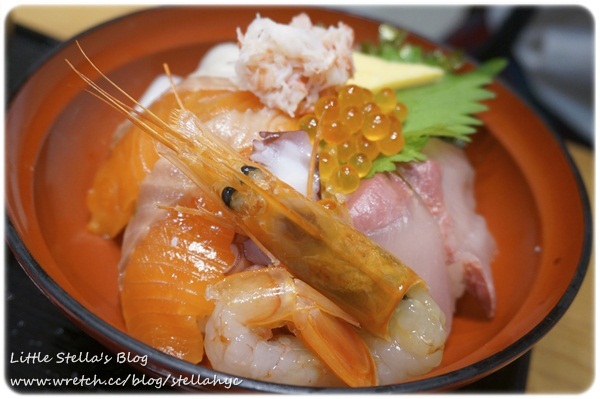 closeup of shrimp with other food items in an orange dish