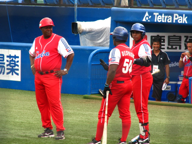 a group of men in red uniforms standing on a field