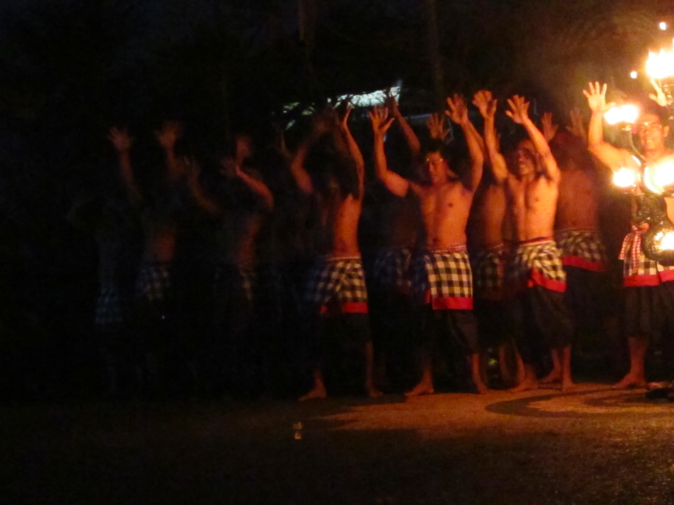 a group of people standing next to each other with their hands up