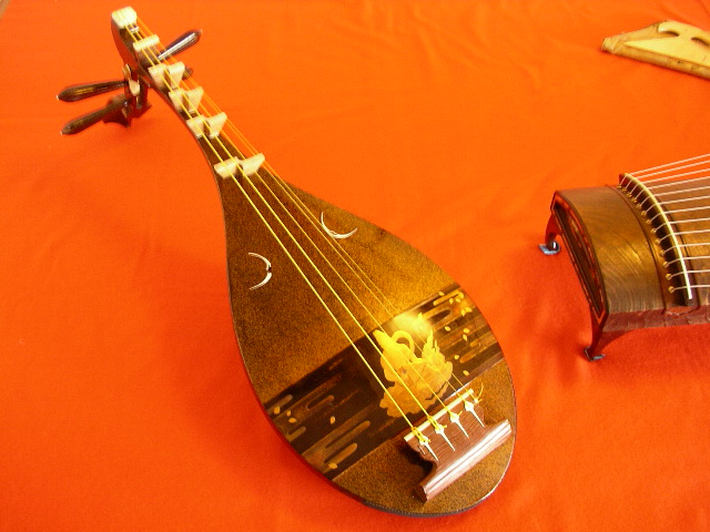two wooden music instruments are on an orange cloth
