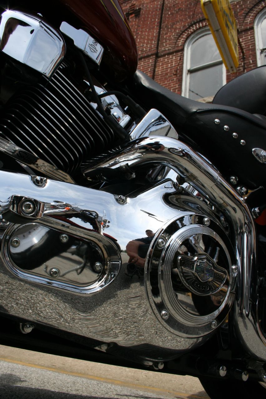 the chrome front end of a motorcycle parked in front of a building