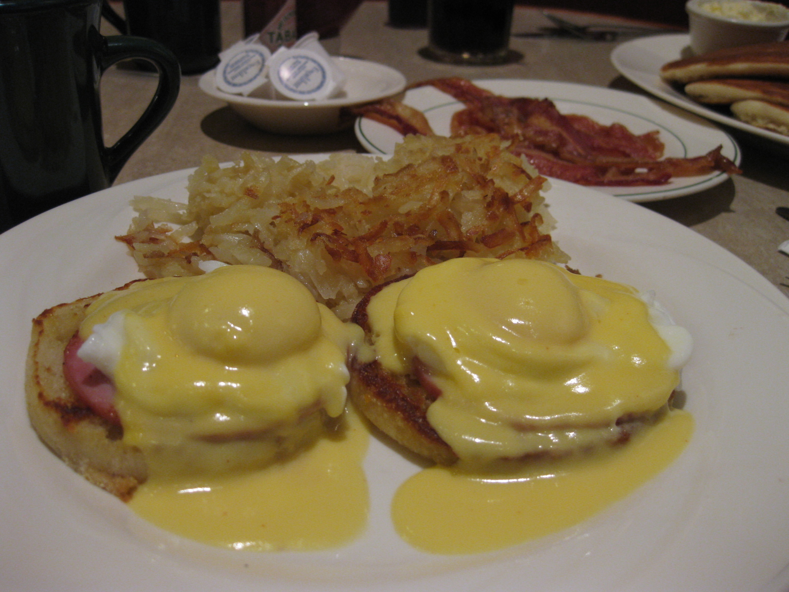 two egg benedicts with mustard are on a plate