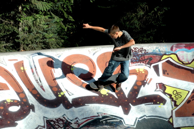 a man skateboarding on the side of a wall