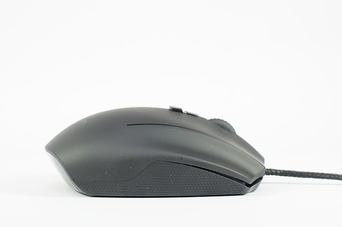 there is a black computer mouse that is on the desk