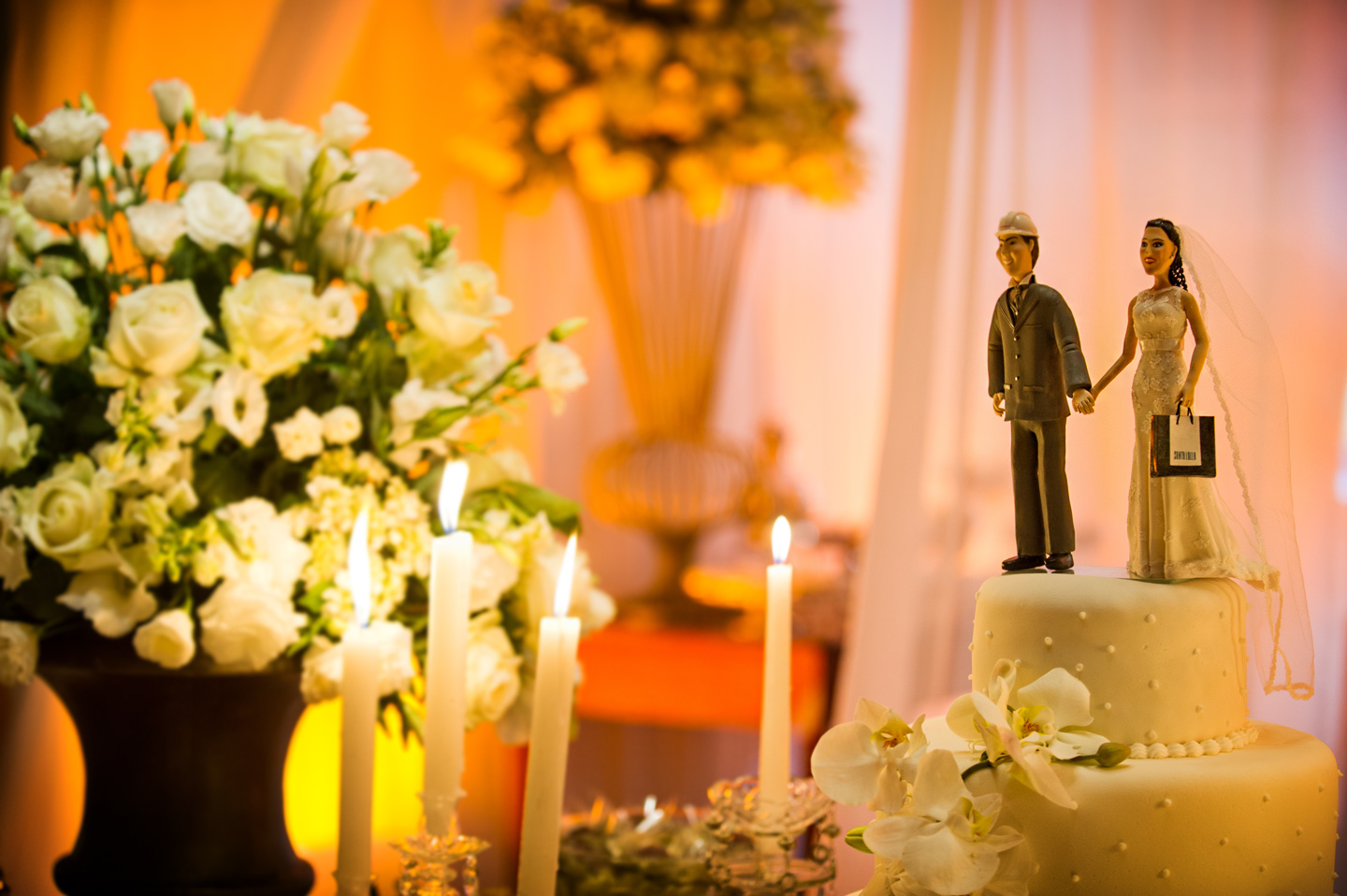 a bride and groom cake topper on a table