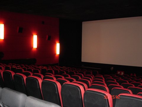 empty seats sitting in the middle of a cinema