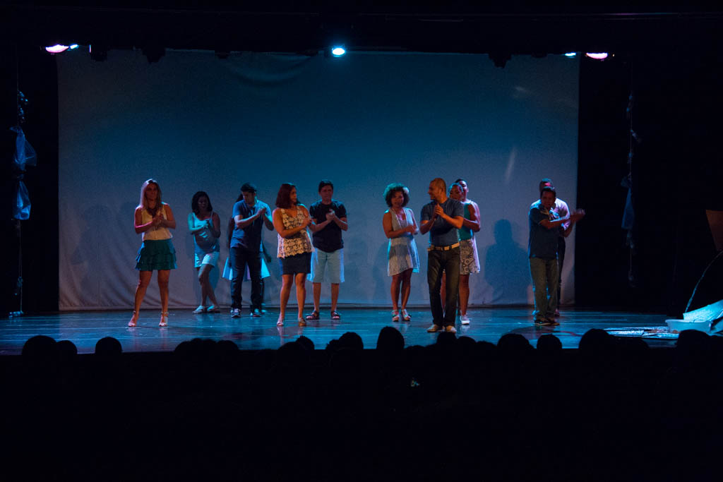 a group of women stand together on a stage