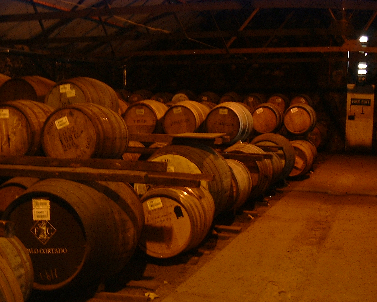 a bunch of wine barrels are stacked together