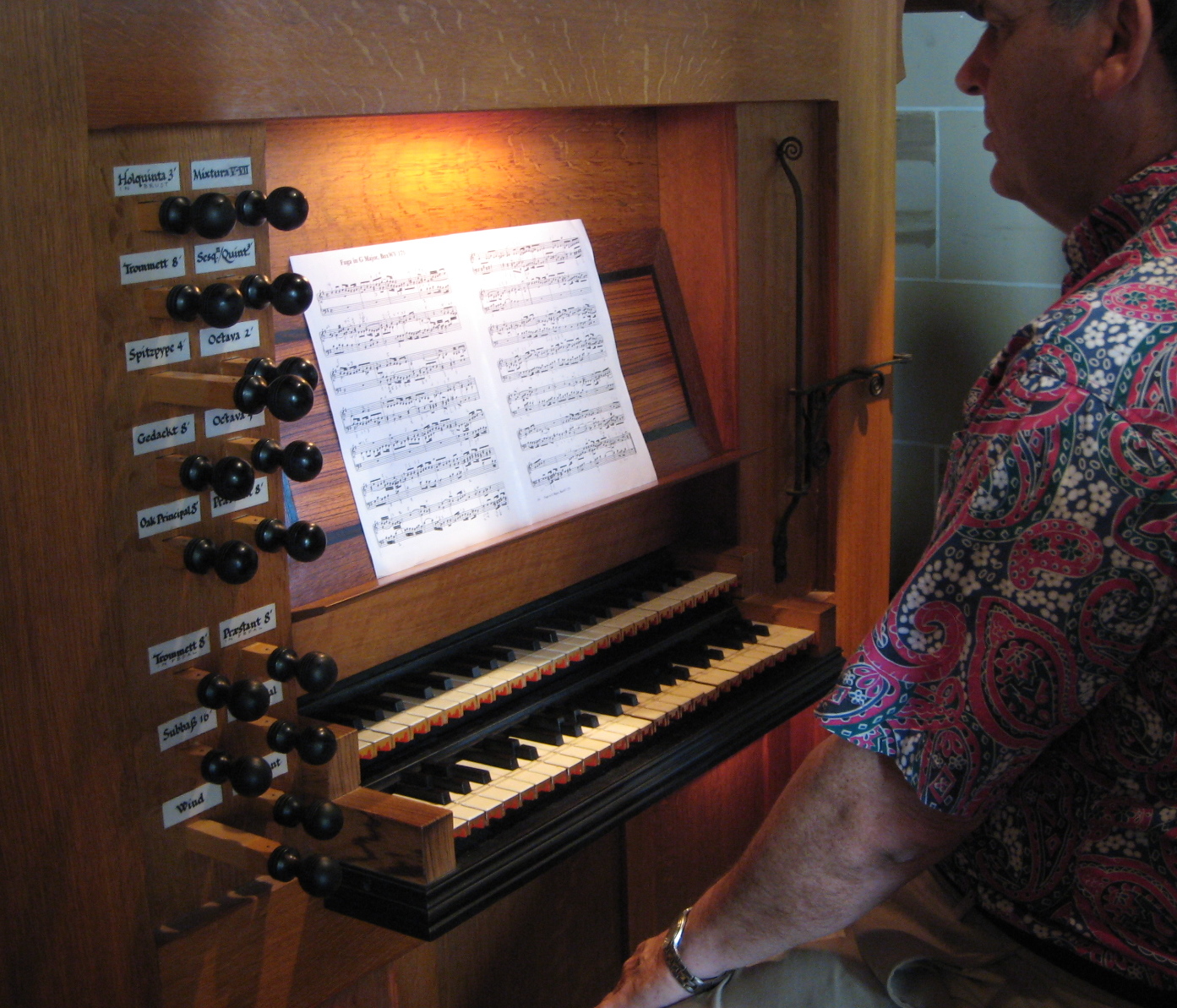 a man playing a music organ with sheet music on it