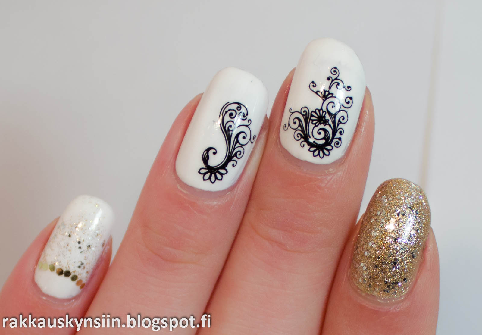 a person is holding a white mani with black designs on it