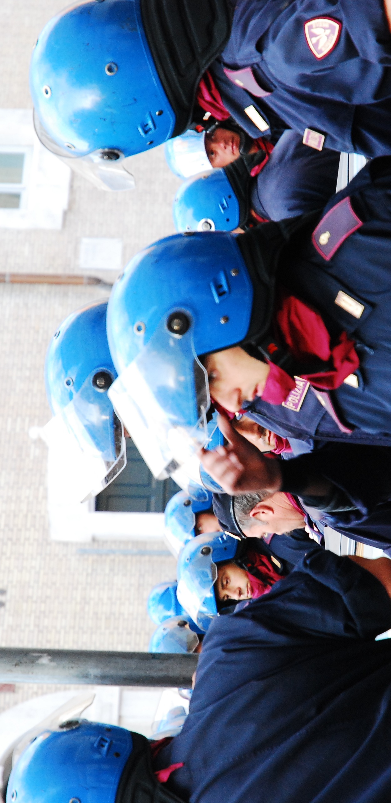 police wearing blue helmets and a red neck scarf on the back