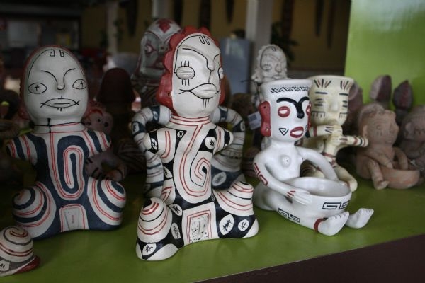 several different colorful ceramic animal figurines, sitting on display