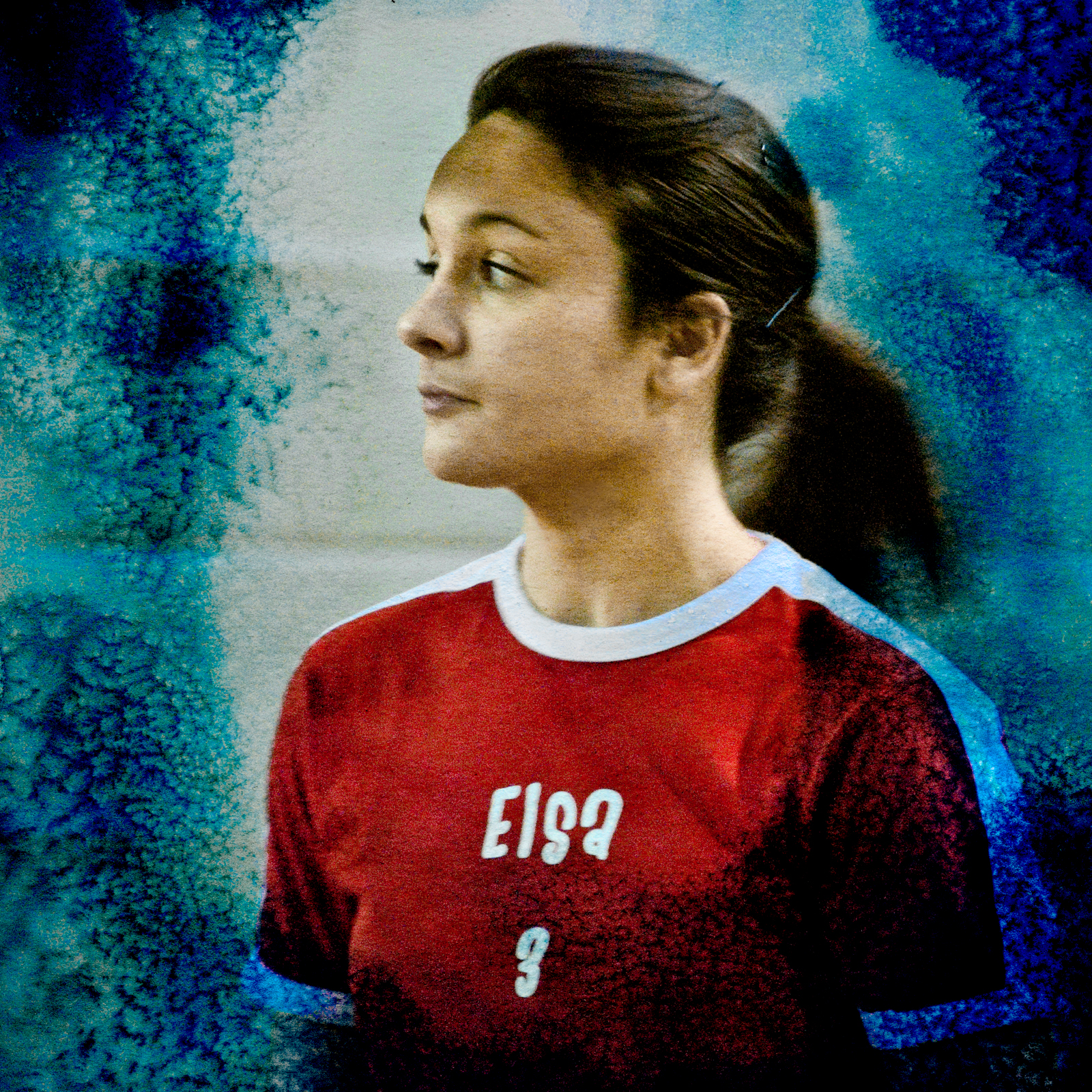 a girl wearing a red and blue jersey looking back