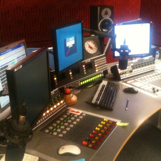 a recording console is decorated with multiple instruments