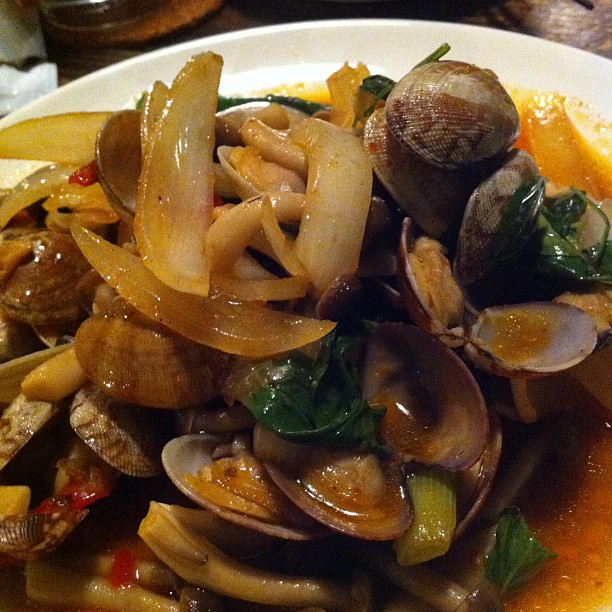 a white plate topped with clams and onions