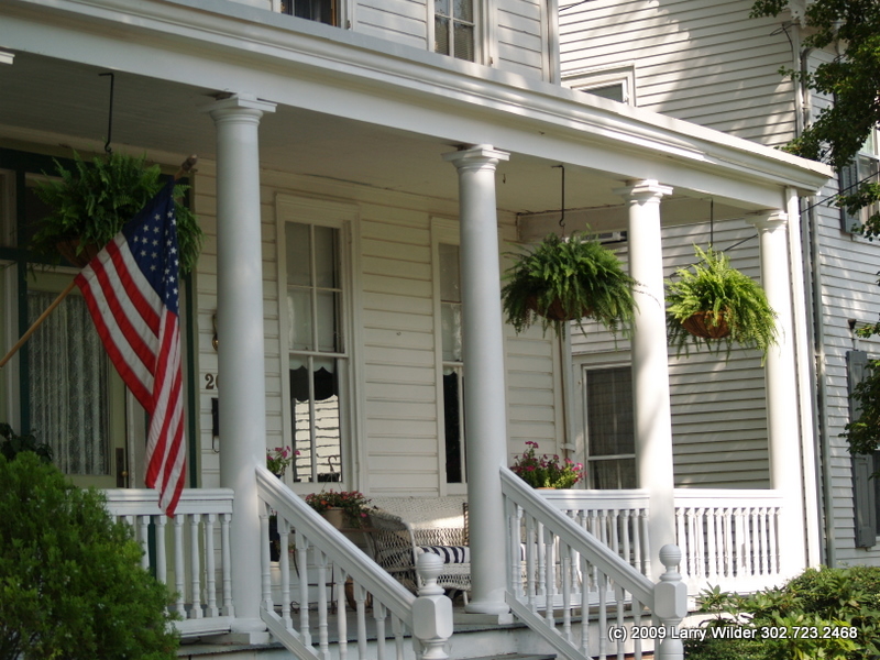 a american flag on the front porch of a house