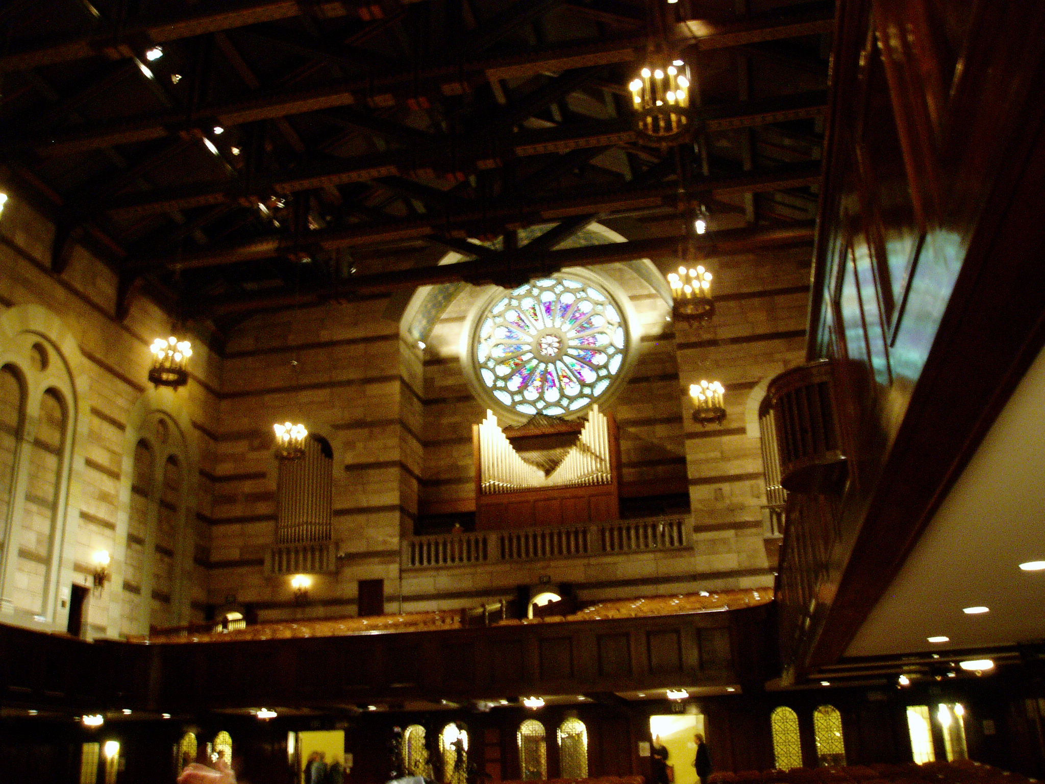 the large stained glass window sits inside the ornate building