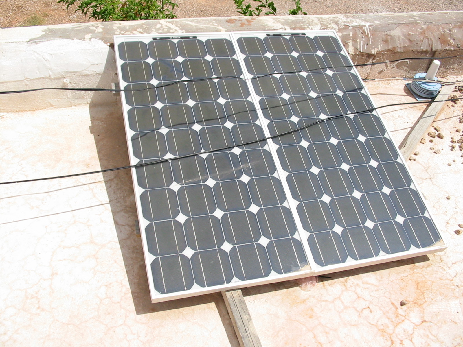 a solar panel sitting on top of a cement slab