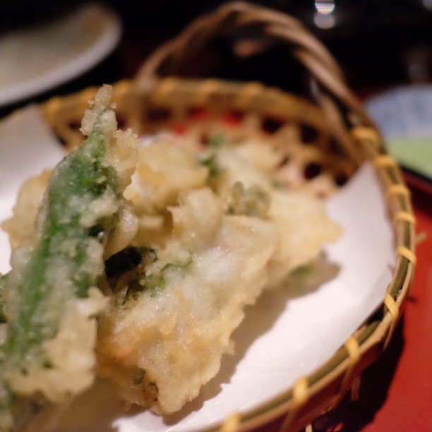 food in a wicker basket on a red table