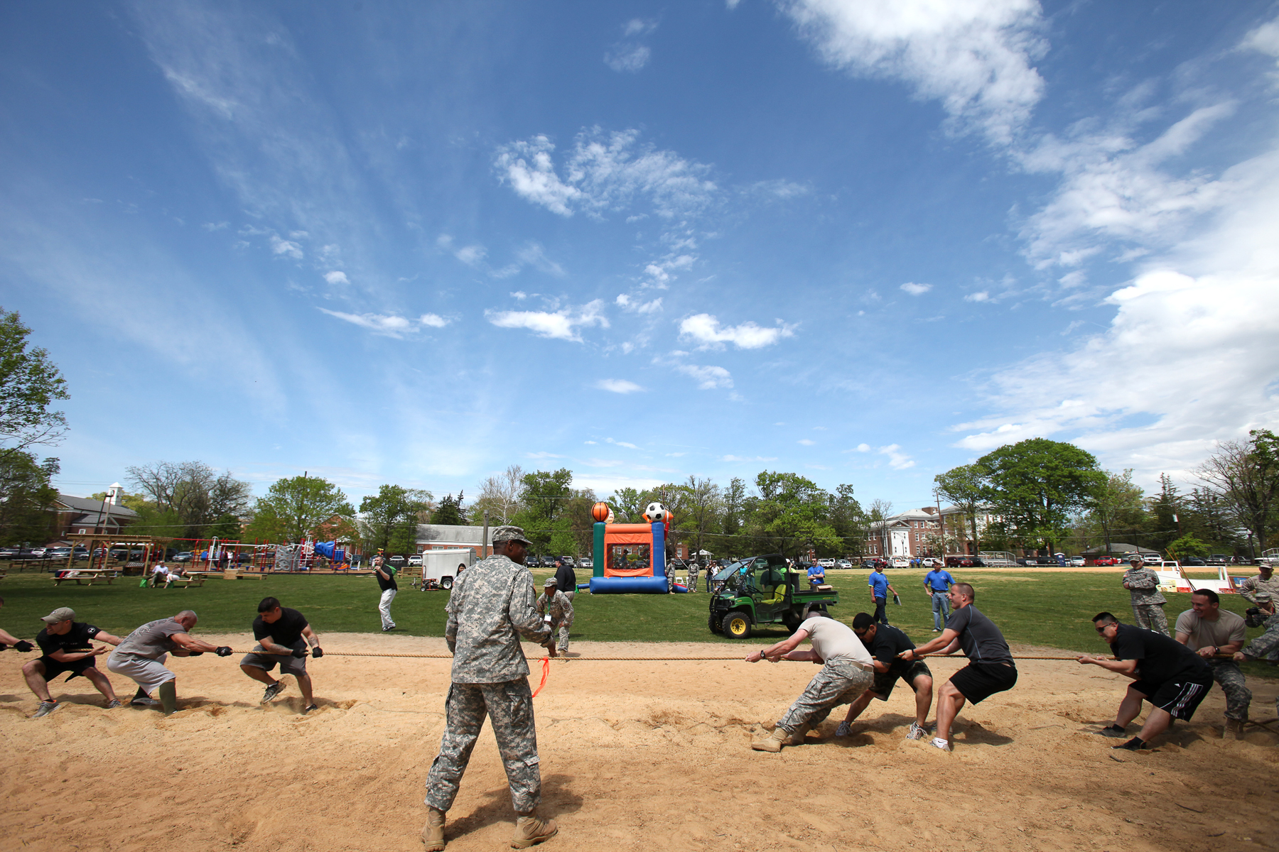 several men at a baseball field are playing baseball