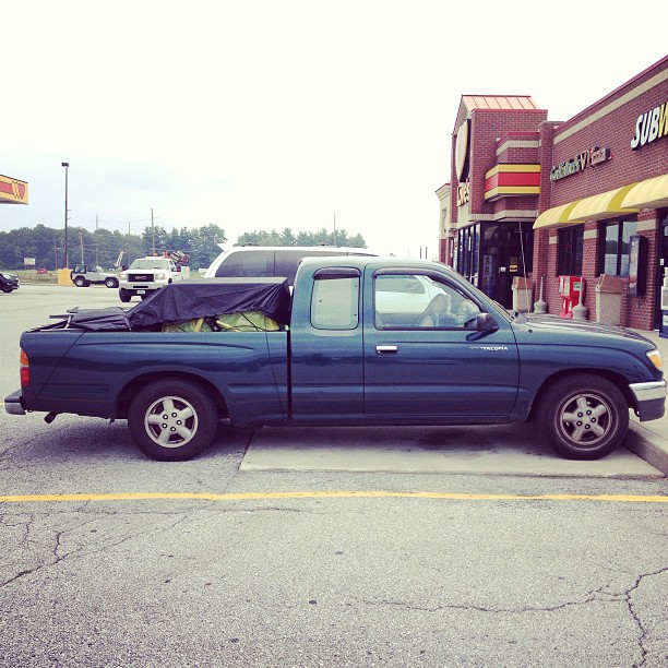 the pick up truck is parked on the street