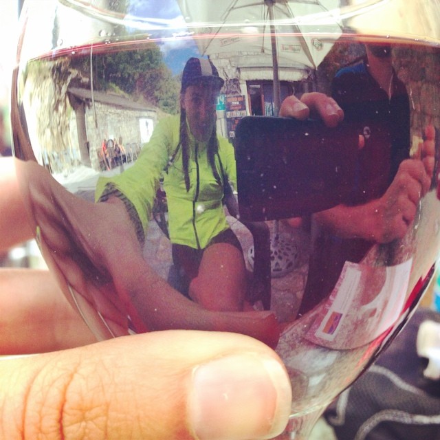 a person holding a wine glass with one hand