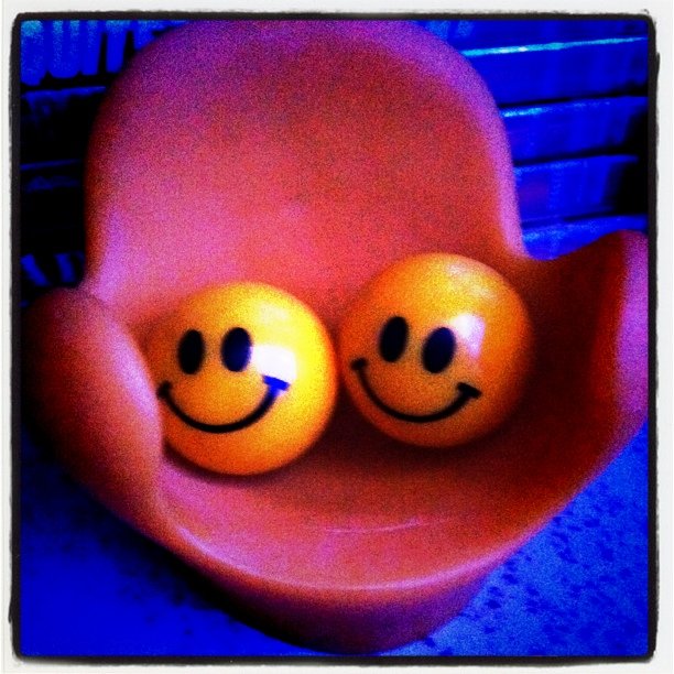 some yellow eggs sitting on a red bowl