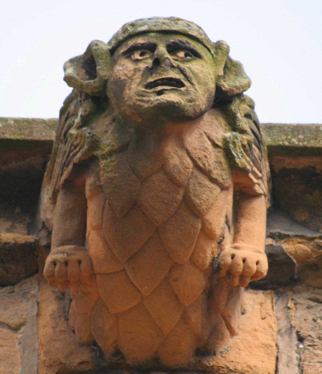 a stone statue with a bird perched on the top