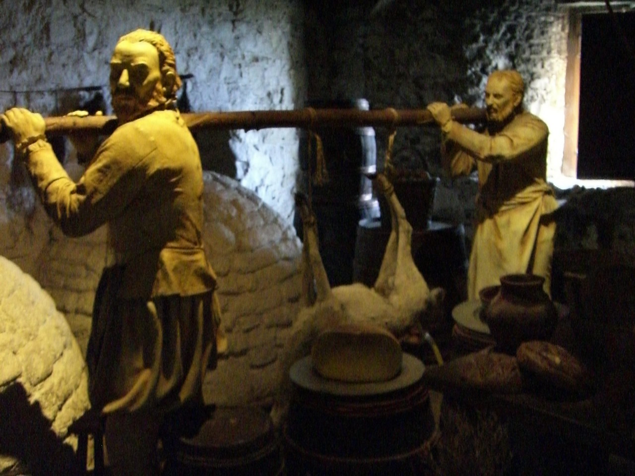 a man standing next to another man in a room