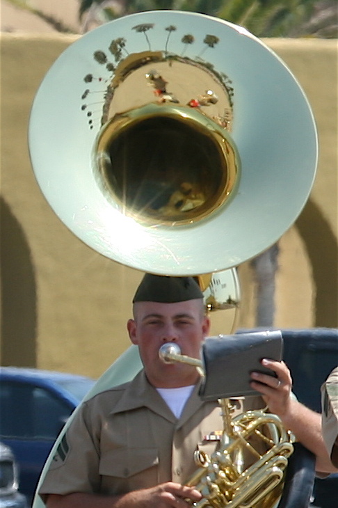 a man playing an instrument on his head