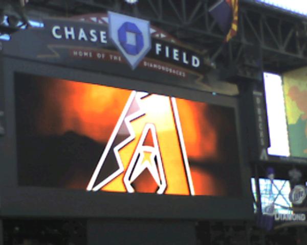 a screen in a stadium shows a chase field logo