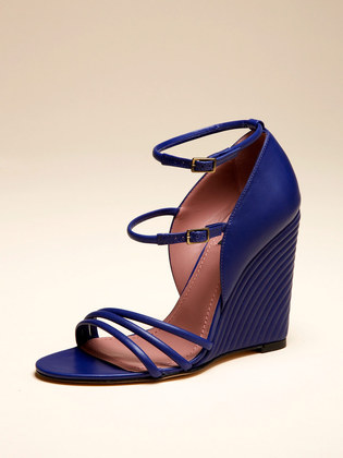 a pair of blue shoes with straps and high heels