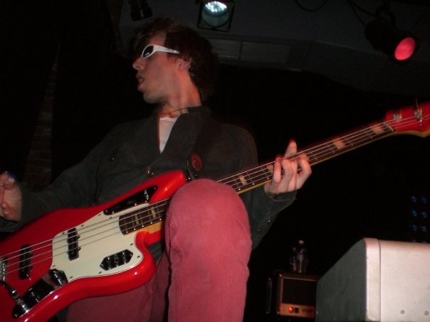 a person sitting down playing a bass