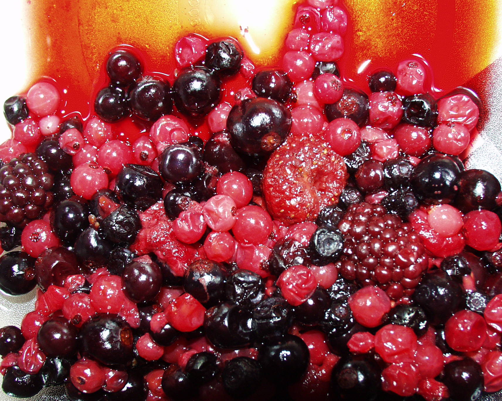 berries and other fruit sitting on top of a surface