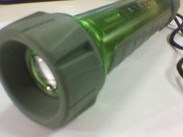 a green flashlight is on top of the table