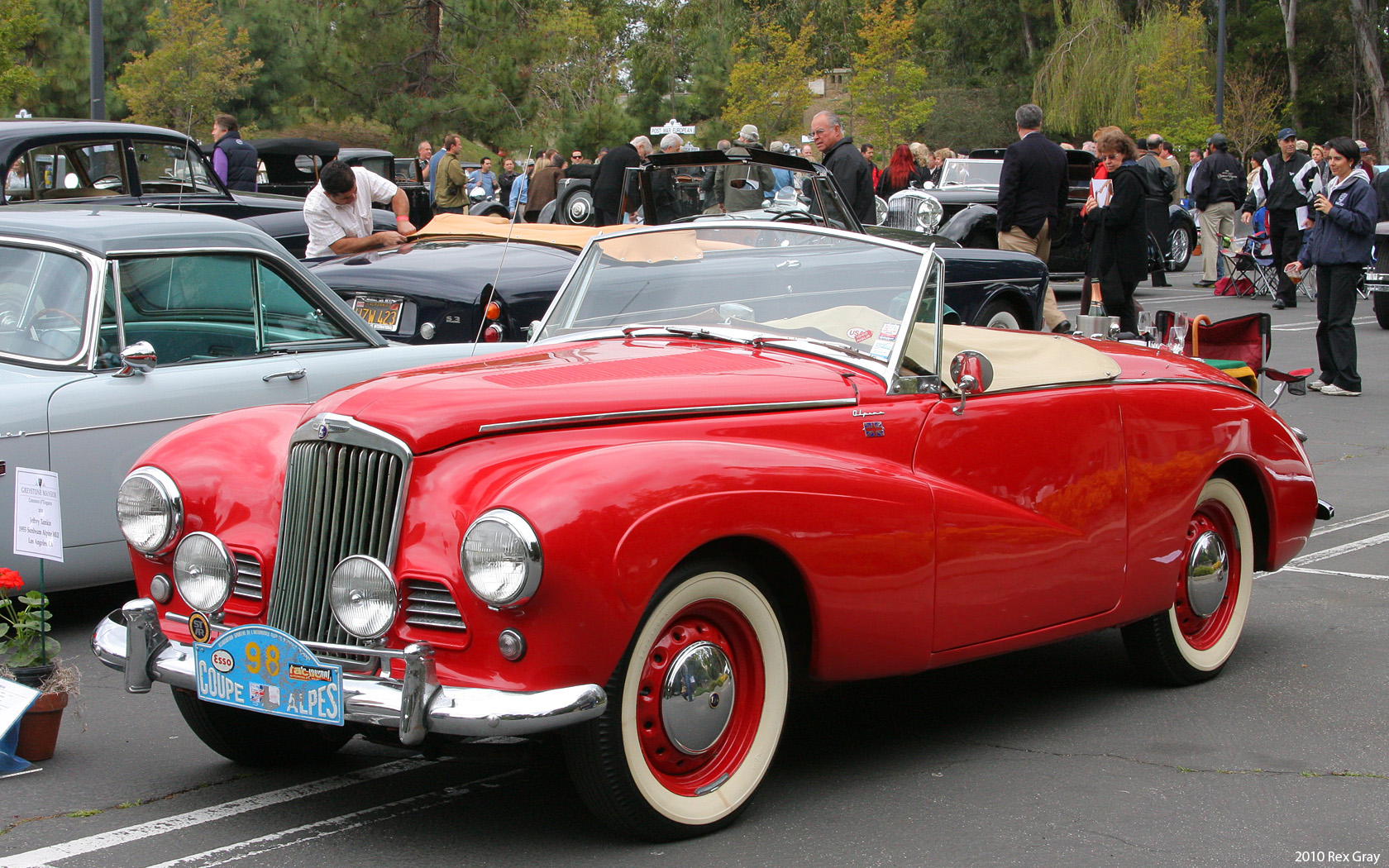 an old red car parked next to another red car